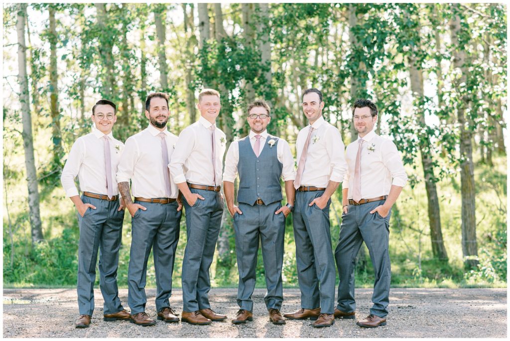 Groomsmen in white shirts and grey pants